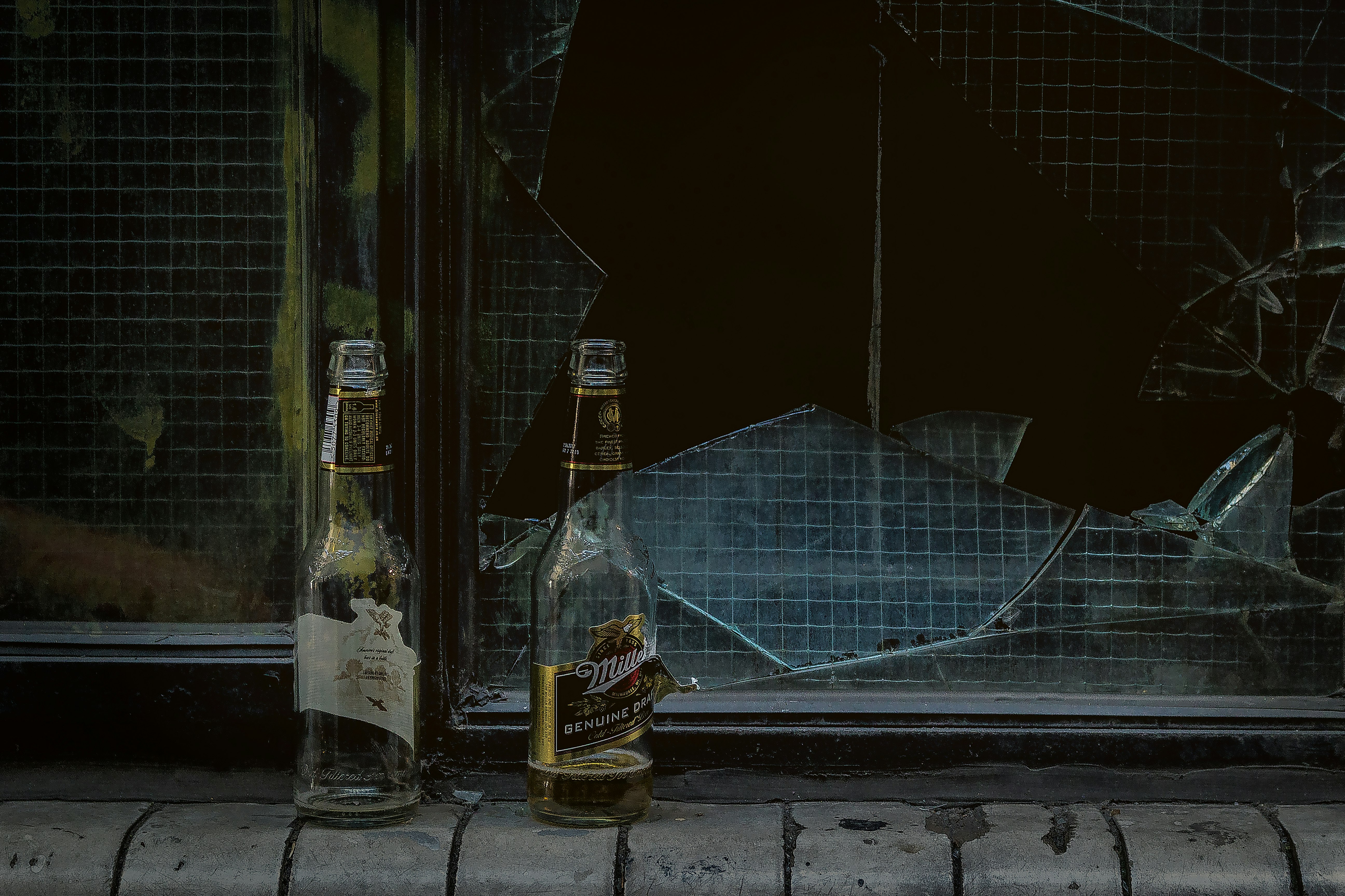 two wine bottles near door